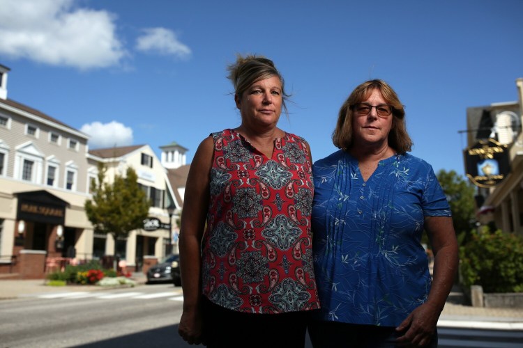 Sisters Sally Tartre, left, and Donna Hart, whose brother, James Roux, was a passenger on Flight 175, the second plane to strike the World Trade Center towers, stand for a portrait Tuesday on Main Street in Kennebunk. 