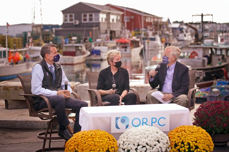 PORTLAND, ME – SEPTEMBER 10: Secretary of Energy Jennifer Granholm, center and Stuart Davies, CEO of Ocean Renewable Power Company listen as Sen. Angus King asks Davies a question while seated at the Portland waterfront on Friday. Granholm visited Portland to talk about the federai government infrastructure spending plan. Ocean Renewable Power Company receives grants from the Department of Energy to develop and install their hyrdroelectric turbines, which generate electricity from river and tidal currents. (Staff photo by Gregory Rec/Staff Photographer)