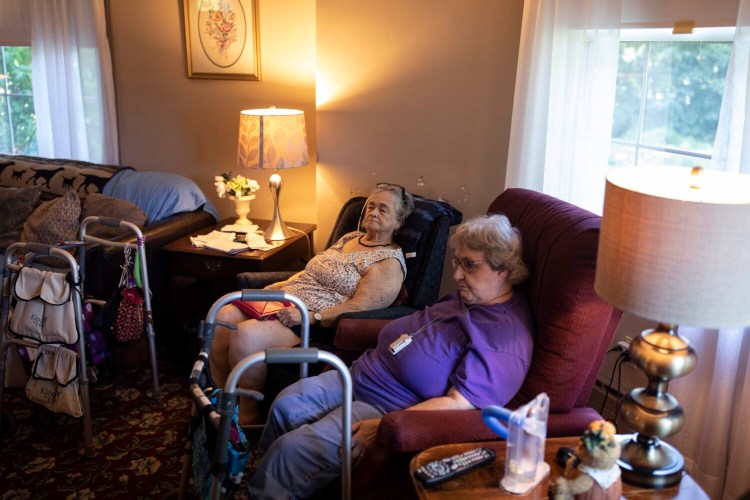 BIDDEFORD, ME - SEPTEMBER 17: Darellene Hussey, 82, left, and Velma Newcomb, 77, watch a movie together before lunch at Shaw House Residential Care on Friday, September 17, 2021. The small 20-bed nursing home in Biddeford is closing in the fall for a variety of reasons, but staffing frustrations amid the pandemic was a big factor. Newcomb has lived at the home for about 12 years and Hussey for almost three years. When the home closes Hussey said she is going to try to get her own place. “I don’t want to move to a big facility,” she said. “I like it here because it is so small.” (Staff photo by Brianna Soukup/Staff Photographer)