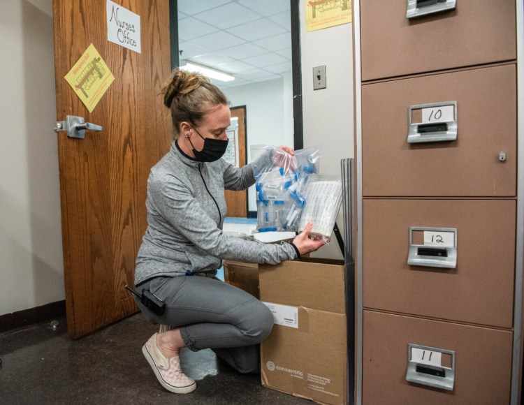 Lewiston High School nurse Missy Gendron unpacks pooled COVID-19 testing materials Sept. 21 at the school. Classroom pooled testing is planned to begin either this week or next. Consent is being collected from parents.