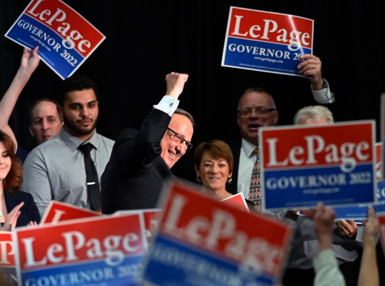 Former Gov. Paul LePage pumps a fist as he walks off the stage at the Augusta Civic Center on Wednesday. He promised a strategic effort to eliminate Maine's income tax if he returns to office.