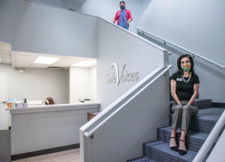 Elise Johansen, executive director of Safe Voices, sits in the lobby of the organization's new space on Lisbon Street. The agency supports survivors of domestic abuse and operates emergency shelters.