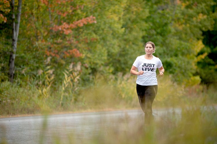Kim Young runs Thursday morning near her Lisbon home. She will participate in the Maine Marathon in Portland on Sunday to bring awareness of a rare cancer she was diagnosed with this year.