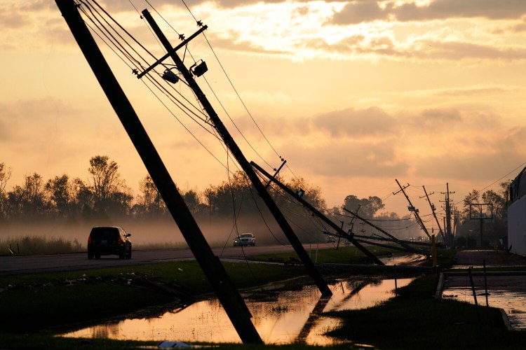 Downed power lines slump over a road in the aftermath of Hurricane Ida on Friday in Reserve, La.