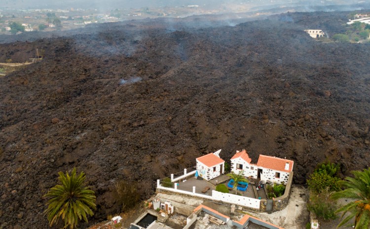 Lava from a volcano eruption flows destroys houses on the island of La Palma in the Canaries, Spain, on Tuesday. The eruption has so far destroyed around 190 houses and forced the evacuation of 6,000 people.