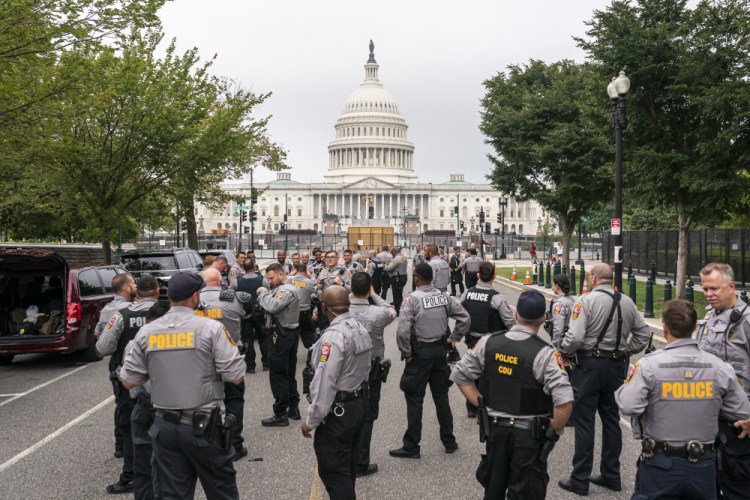 Police stage at a security fence ahead of a rally Saturday near the U.S. Capitol in Washington on Saturday. The rally was planned by allies of former President Donald Trump and aimed at supporting the so-called "political prisoners" of the Jan. 6 insurrection at the U.S. Capitol. (AP Photo/Nathan Howard)