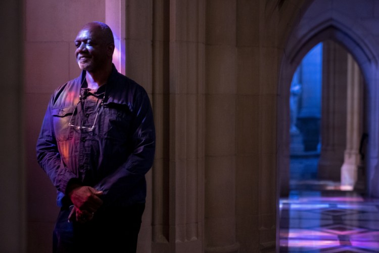 Artist Kerry James Marshall poses for a portrait in the National Cathedral in Washington after being selected to design a replacement of former confederate-themed stained glass windows that were taken down in 2017.