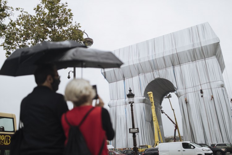 Workers wrap the Arc de Triomphe monument on Wednesday "L'Arc de Triomphe, Wrapped" project by late artist Christo and Jeanne-Claude will be on view from, Sept. 18 to Oct. 3. 