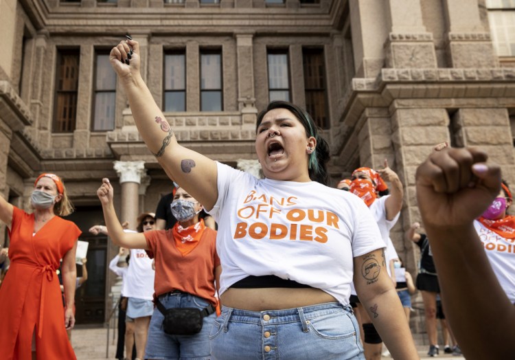 Leen Garza participates in a protest against the six-week abortion ban at the Capitol in Austin, Texas, on Wednesday. Dozens of people protested the Texas abortion restriction law that went into effect Wednesday. 