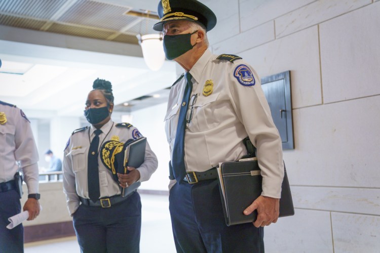 U.S. Capitol Police Chief Thomas Manger, joined at left by Assistant Chief Yogananda Pittman, heads to a closed-door meeting with congressional leaders for a briefing as security officials prepare for a Sept. 18 demonstration by supporters of the people arrested in the Jan. 6 riot, at the Capitol in Washington on Monday. 