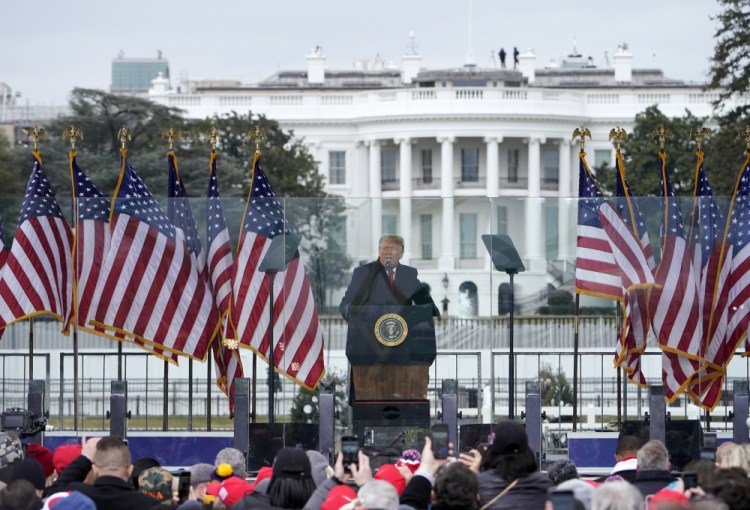With the White House in the background, then-President Trump speaks at a rally in Washington on the day Joe Biden was certified as winner of the election. At the end of the rally Trump loyalists beat and injured police as they battled their way inside the U.S. Capitol, destroyed property and sent lawmakers running for their lives.