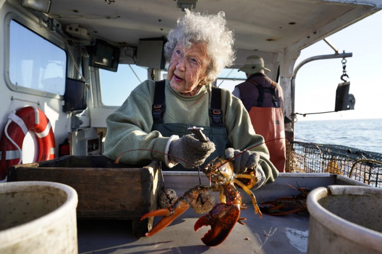 Virginia Oliver, age 101, works as a sternman, measuring and banding lobsters on her son Max Oliver's boat off Rockland in late August.