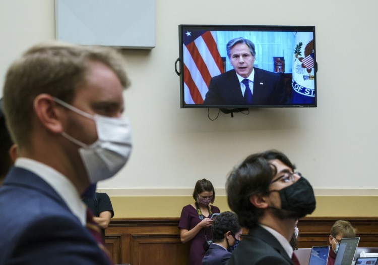 Secretary of State Antony Blinken appears remotely on a TV monitor to answer questions from the House Foreign Affairs Committee about the U.S. withdrawal from Afghanistan, at the Capitol in Washington on Monday.