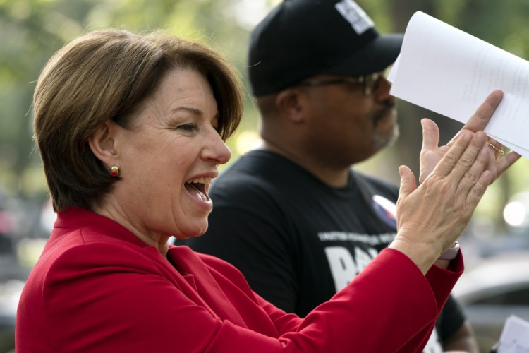Sen. Amy Klobuchar, D-Minn., left, and Cliff Albright, executive director of Black Voters Matter, attend a rally for voting rights on Tuesday on Capitol Hill in Washington. 