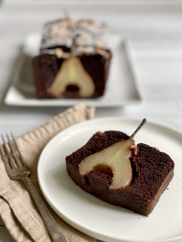 A slice of Poached Pear, Chocolate and Hazelnut Cake. Frustrated waiting for pears to reach peak ripeness? Bake this cake. 