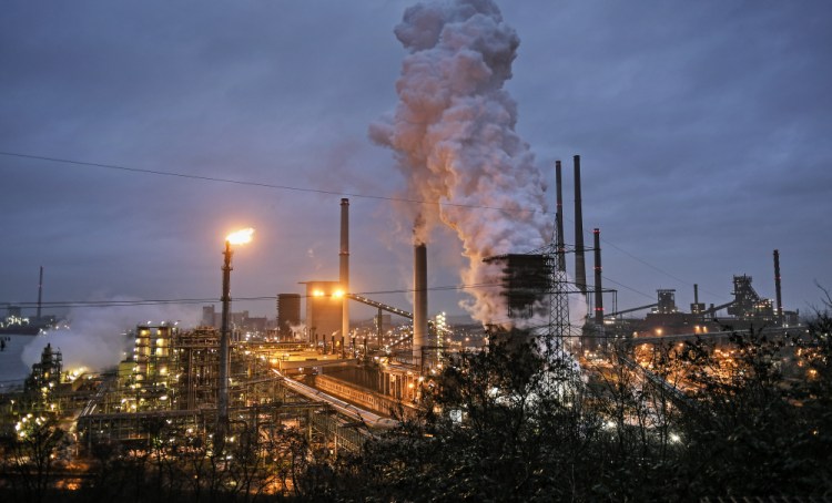 A ThyssenKrupp coking plant steams around the clock for the nearby steel mill in Duisburg, Germany, in Jan., 2020. The cuts in greenhouse gas emissions pledged by governments around the world aren't enough to achieve the headline goal of the Paris climate accord, according to a United Nations report published Friday.
