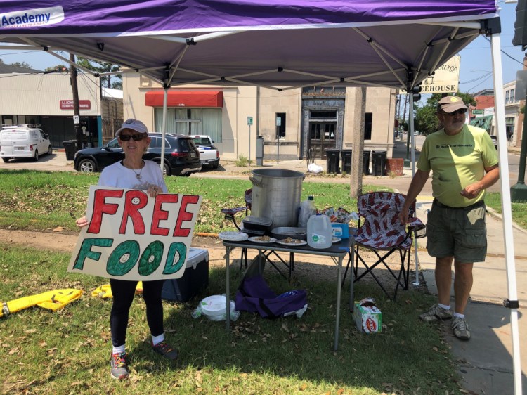 Joyce and Dave Thomas offer free jambalaya, cooked up by one of their neighbors, along the Carrollton streetcar tracks in New Orleans on Thursday.