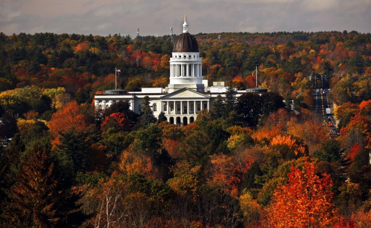 The State House is surrounded by fall foliage in Augusta in this photo from Oct. 23, 2017. Recent leaf-peeping seasons have been disrupted by weather conditions in New England, New York and elsewhere. Arborists and ecologists say the trend is likely to continue as the planet warms. 