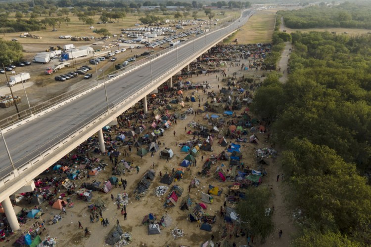 Migrants, many from Haiti, are seen at an encampment along the Del Rio International Bridge near the Rio Grande on Tuesday in Del Rio, Texas. 