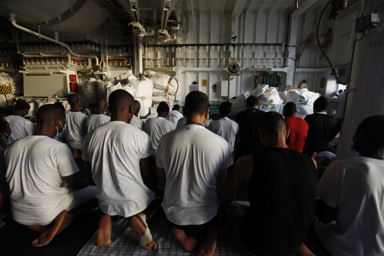Migrants pray on the deck of the Geo Barents, a rescue vessel operated by Doctors Without Borders, off Libya on Sept. 22.

