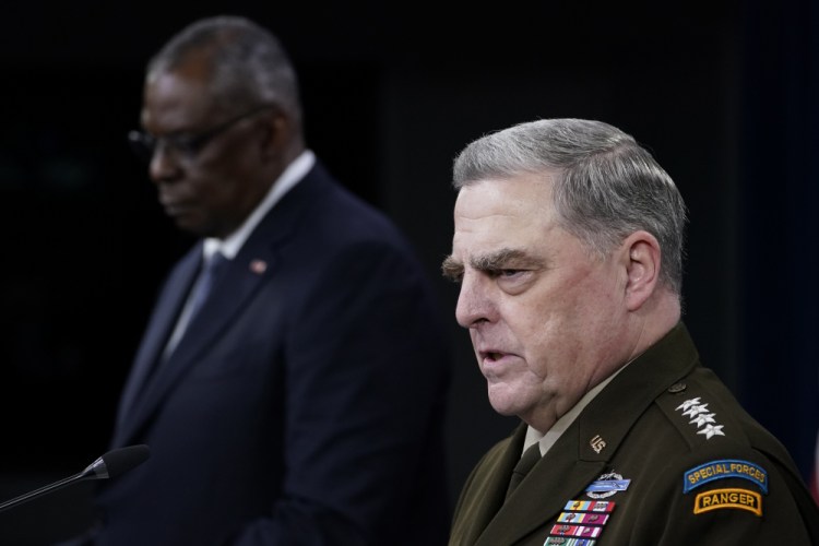 Joint Chiefs of Staff Gen. Mark Milley, right, answers a question during a briefing with Secretary of Defense Lloyd Austin, left, at the Pentagon in Washington on Wednesday about the end of the war in Afghanistan. 