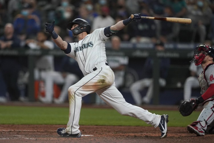 Seattle Mariners' Mitch Haniger follows through on a three-run, go-ahead home run against the Boston Red Sox during the seventh inning Monday night in Seattle.