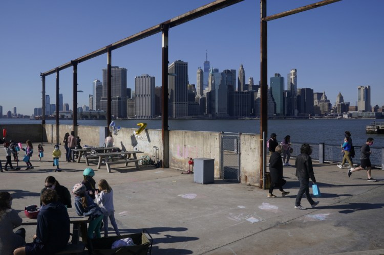 People enjoy the sunny weather and a view of the Manhattan skyline from the Brooklyn waterfront March 21 in New York. The surge in the nation’s urban population could give these urban centers greater influence in reshaping the balance of power in Washington as congressional redistricting gets under way. New York in particular is giving Democrats hope. The most populous city in the United States added some 629,000 new residents.