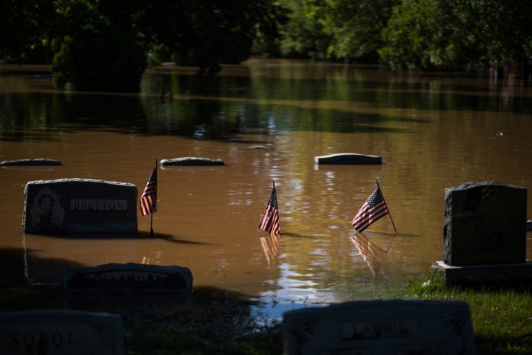 Headstones at a cemetery that flooded are seen in Somerville, N.J., on Thursday. A stunned U.S. East Coast faced a rising death toll, surging rivers, tornado damage and continuing calls for rescue Thursday after the remnants of Hurricane Ida walloped the region with record-breaking rain, drowning more than two dozen people in their homes and cars.