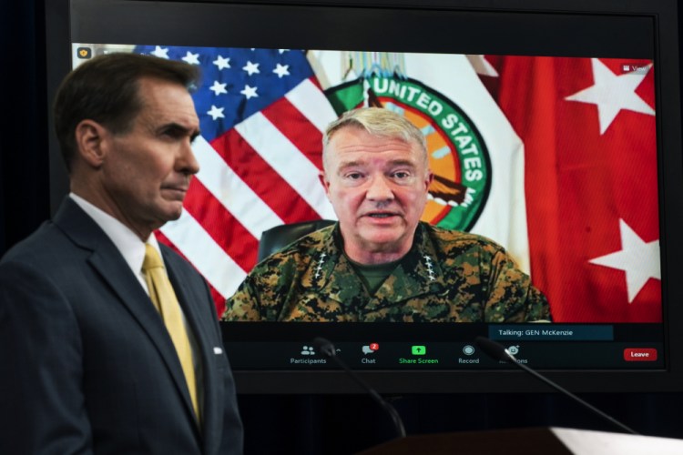 Gen. Frank McKenzie, commander of U.S. Central Command, appears on screen as he speaks from MacDill Air Force Base in Tampa, Fla., in August. At left is Pentagon spokesman John Kirby. 