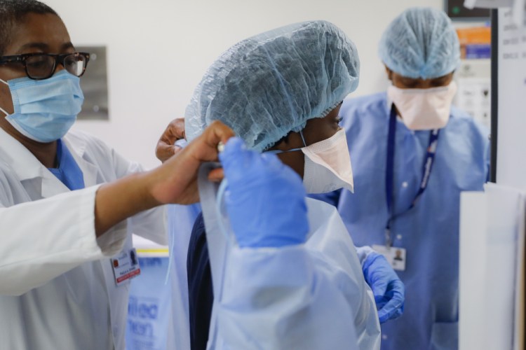 Medical personnel adjust their personal protective equipment while working in the emergency department at NYC Health + Hospitals Metropolitan in New York on May 27, 2020. 
