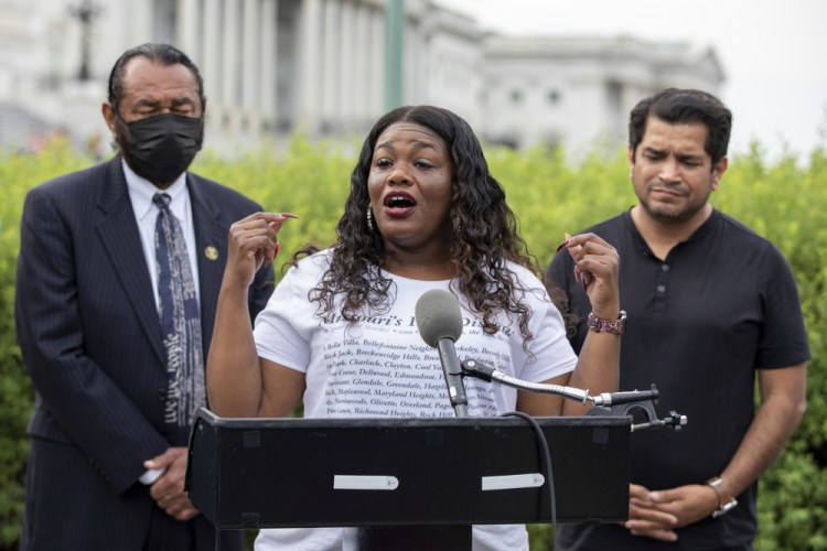 Rep. Cori Bush, D-Mo., flanked by Rep. Al Green, D-Texas, left, and Rep. Jimmy Gomez, D-Calif., right, speaks to the press after it was announced that the Biden administration will enact a targeted nationwide eviction moratorium, on Aug. 3. Several progressive lawmakers, including Bush, on Tuesday, introduced a bill that would reimpose a nationwide eviction moratorium.