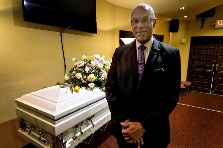 Wayne Bright, funeral director at Wilson Funeral Home poses for a photo in a viewing room before a service Thursday in Tampa, Fla.   


