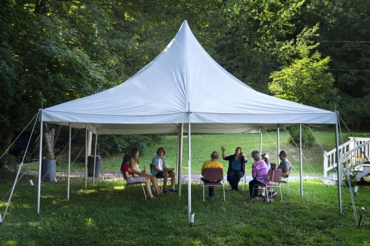 A class in Judaism is held under a tent set upon outside Temple Beth El, on Monday in Augusta. The recent COVID-19 upsurge is disrupting plans for full-fledged in-person services. “The ability to see people face to face is wonderful, whatever way they choose to come,” Rabbi Erica Asch says. “But there’s a little bit of sadness that we can’t all be together the way we’d like.” 