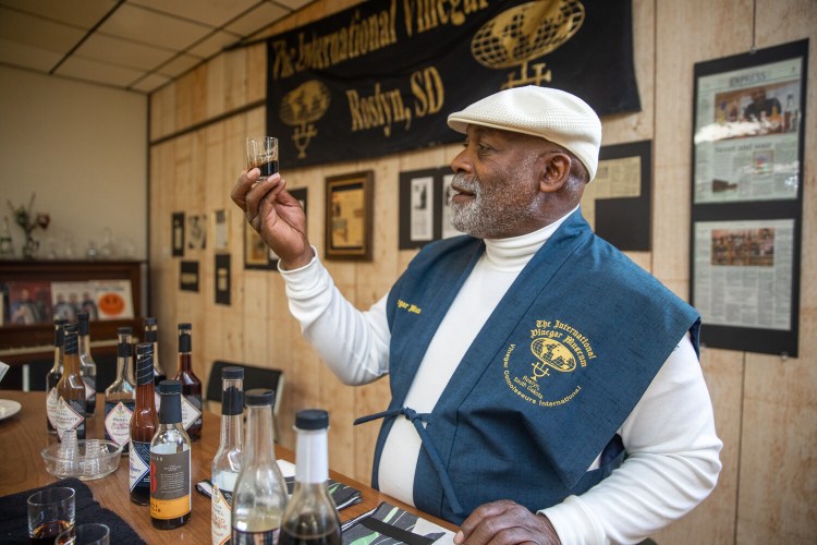 Lawrence Diggs, founder of the International Vinegar Museum in Roslyn, S.D., with some of the 300 bottles in its collections. MUST CREDIT: Photo for The Washington Post by Jay Pickthorn