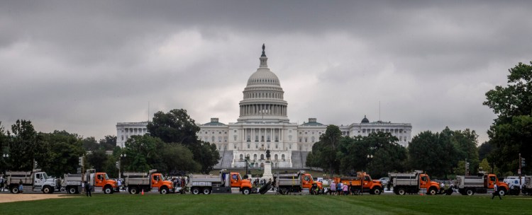 A row of dump trucks parked bumper to bumper as enhanced security around the Capitol for the Justice for J-6 protest rally, in Washington, D.C. MUST CREDIT: Washington Post photo by Bill O'Leary.