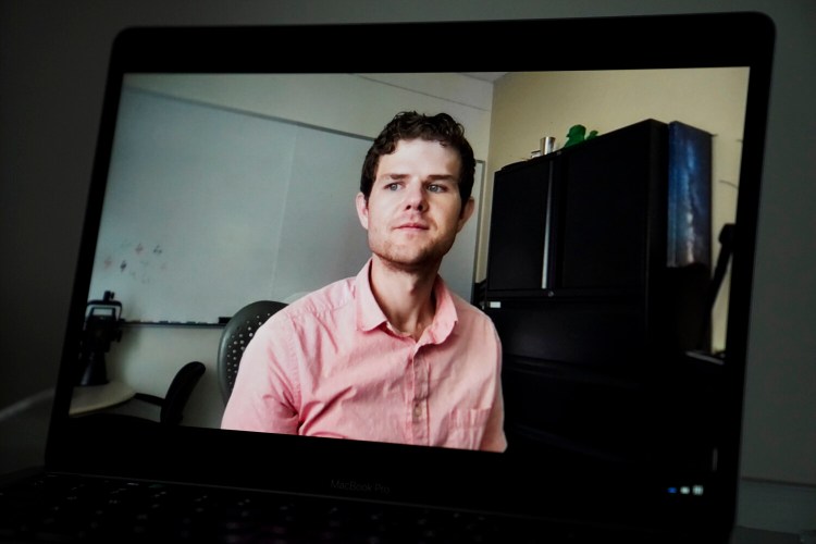 Nick Kneer is shown in his office in Oxford, Ohio, as seen via Zoom on a laptop.