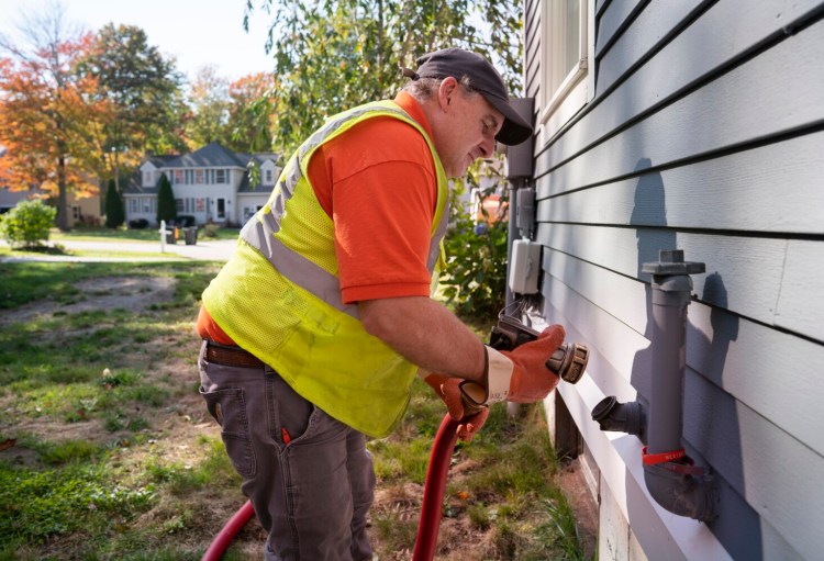 SCARBOROUGH, ME - OCTOBER 13: Paul Sabato, a driver with Heatable, delivers oil to a home in Scarborough on Wednesday, October 13, 2021. After a lull during the pandemic, home energy prices are expected to climb this winter. (Staff photo by Gregory Rec/Staff Photographer)