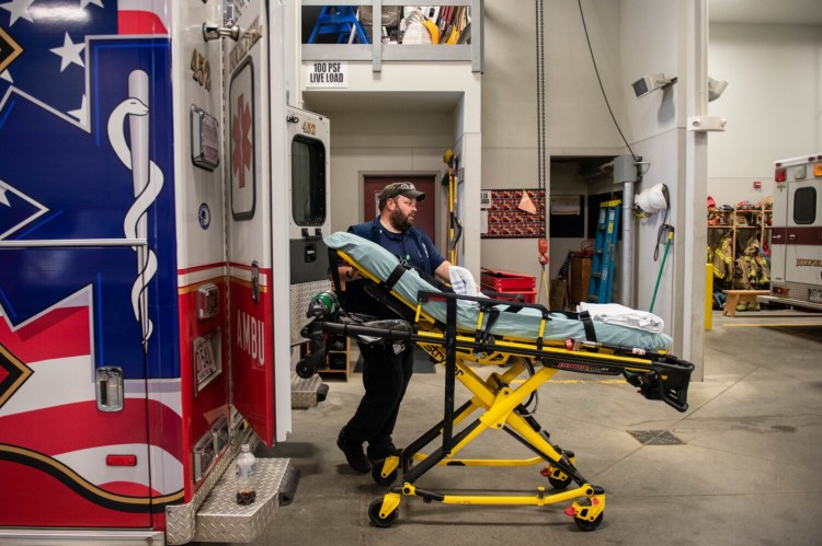 Norman Richardson removes a stretcher from an ambulance for decontamination on Friday at the Buckfield EMS department after spending a day helping out a mutual aid department. Richardson and another paramedic had the day off and answered the call to help another short-staffed department in the area.