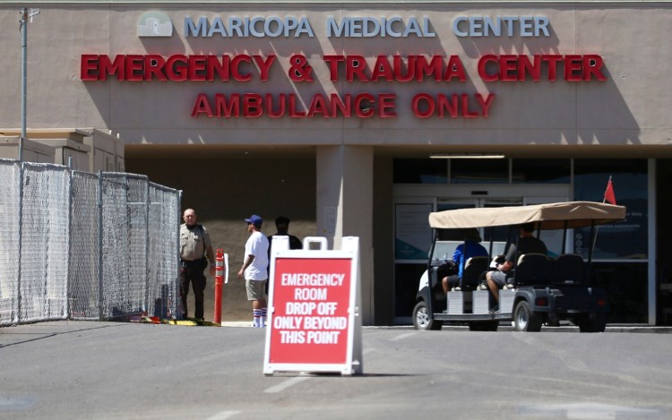 FILE - This June 10, 2020, file photo, shows the emergency room entrance at Valleywise Health Center hospital in Phoenix. Arizona is continuing to see slight downward trends with coronavirus hospitalizations as officials find more related deaths. (AP Photo/Ross D. Franklin, File)