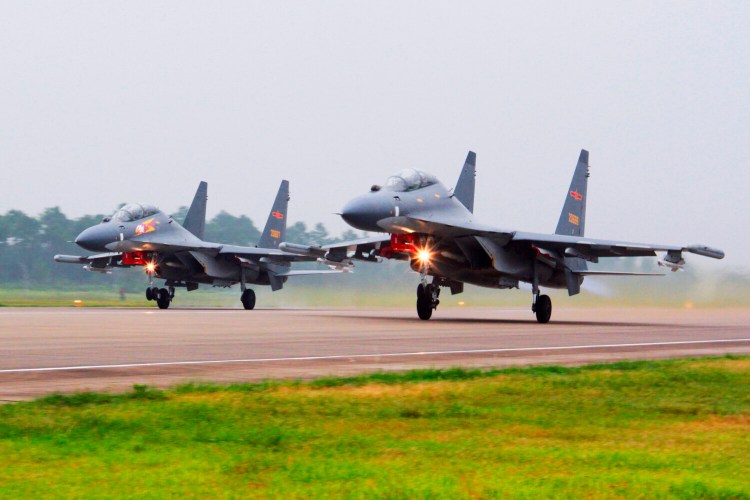 FILE - In this undated file photo released by China's Xinhua News Agency, two Chinese SU-30 fighter jets take off from an unspecified location to fly a patrol over the South China Sea. China flew more than 30 military planes, including SU-30 fighter jets, toward Taiwan on Saturday, Oct. 3, 2021, the second large display of force in as many days.(Jin Danhua/Xinhua via AP, File)