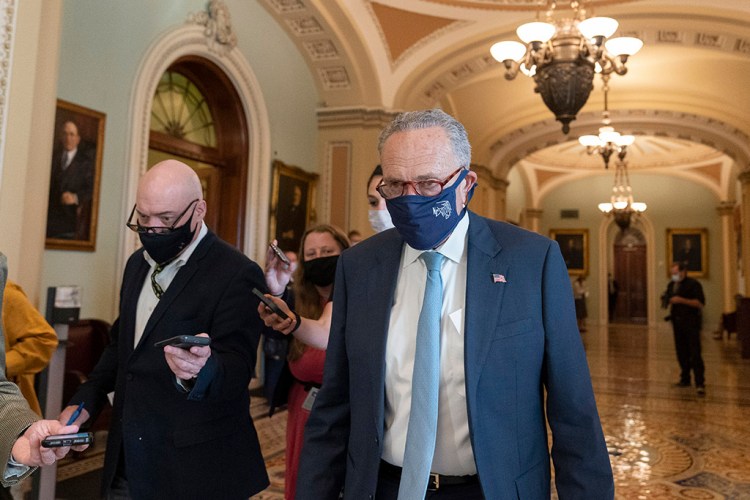 Senate Majority Leader Chuck Schumer of N.Y., speaks with reporters as he walks to his office on Capitol Hill, Thursday, Oct. 7, 2021, in Washington. (AP Photo/Alex Brandon)