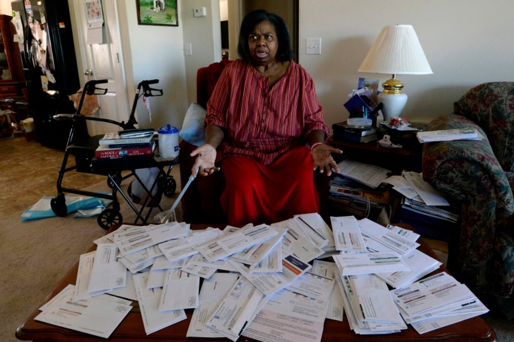 Debra Smith, 57, talks about her medical bills in her living room on Thursday, Oct. 7, 2021, in Spring Hill, Tenn. Smith has around $10,000 in unpaid medical bills from a string of hospital stays over the past year, even though she has coverage through Medicare. She hasn't been able to make much progress paying them off. (AP Photo/Mark Zaleski)