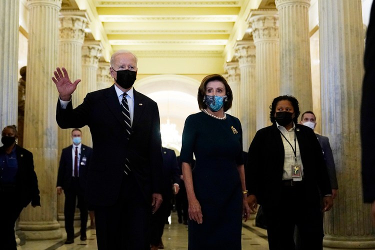 President Biden walks with House Speaker Nancy Pelosi on Capitol Hill on Thursday after meeting with House Democrats.