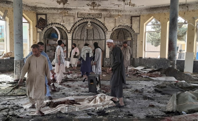 People view the damage inside a mosque following a bombing in Kunduz province in northern Afghanistan on Friday. 