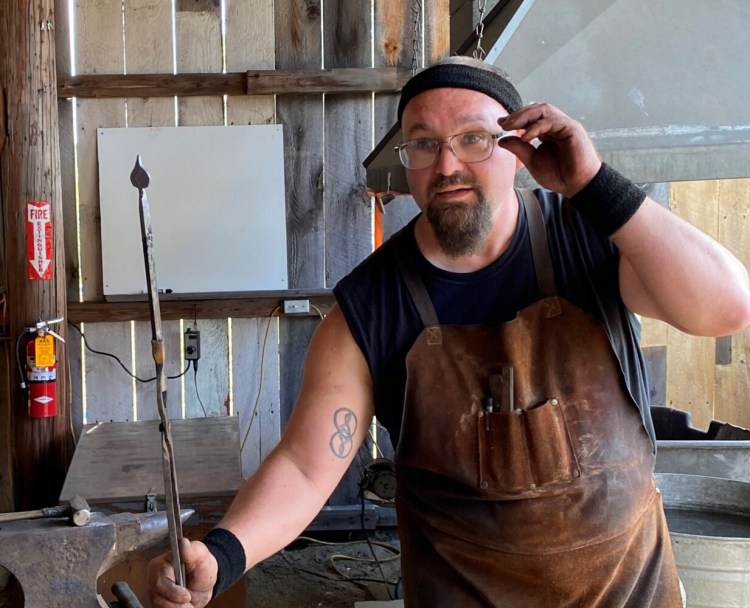 Ryan Adams of Bell Hill Forge in Otisfield demonstrates blacksmithing at the Oxford Fair in Oxford in September. Adams crafted a decorative leaf with an iron rod and 2000-degree fire.