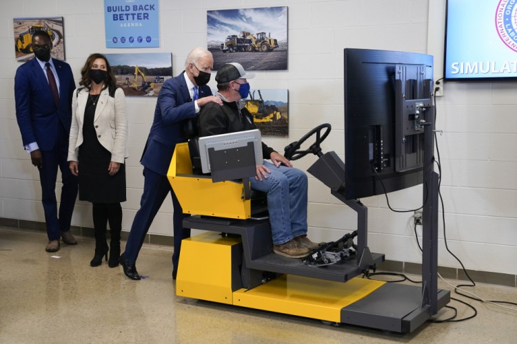 President Biden tours the International Union Of Operating Engineers Local 324 training facility on Tuesday in Howell, Mich. Michigan Lt. Gov. Garlin Gilchrist, left, and Michigan Gov. Gretchen Whitmer, second from left, accompany him. 