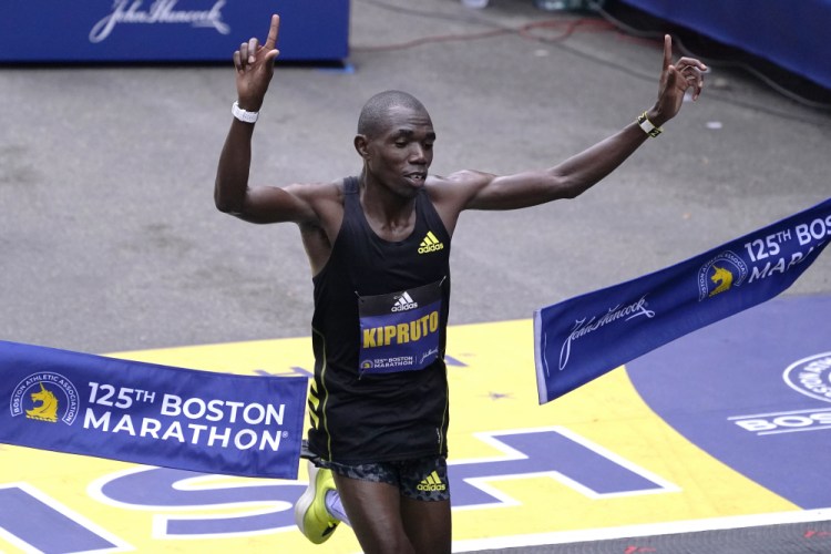 Benson Kipruto, of Kenya, breaks the finish line tape to win the Boston Marathon on Monday.