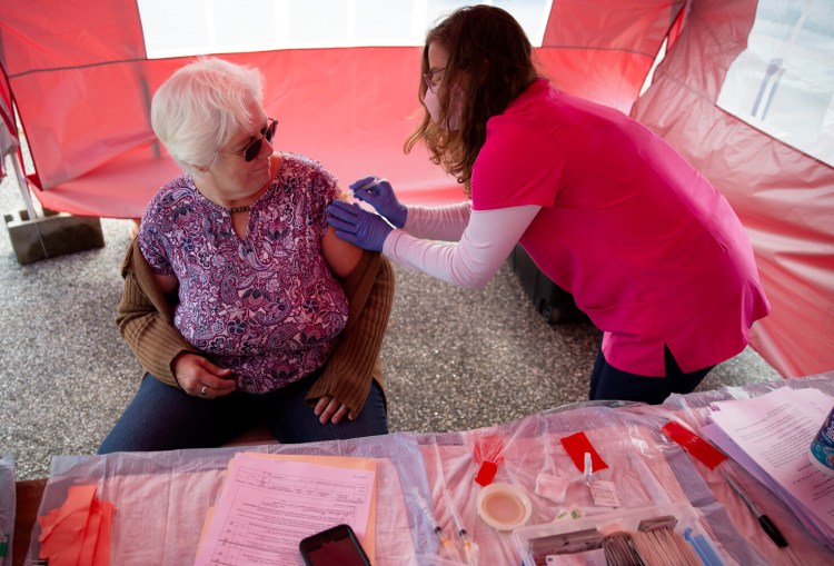 CUMBERLAND, ME - SEPTEMBER 30: Maine CDC administered a vaccination clinic on Thursday at the Cumberland County Fair. Jessica McCurdy gives a Johnson & Johnson shot to Andrea Harmon of Oxford, who said she was getting the vaccination to satisfy requirements for her job as a daily living skills aid. “The reason I am doing this is so I can keep my job”, she said.  (Photo by Derek Davis/Staff Photographer)