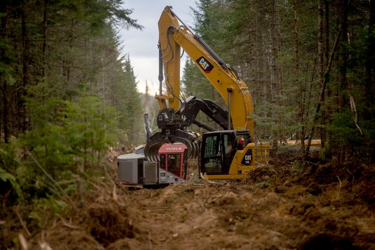 Crews from Northern Clearing Inc. continue to clear a corridor Wednesday on land near Whipple Pond, south of Jackman. The work continued on the day after Maine residents voted to discontinue work on the $1 billion transmission line.