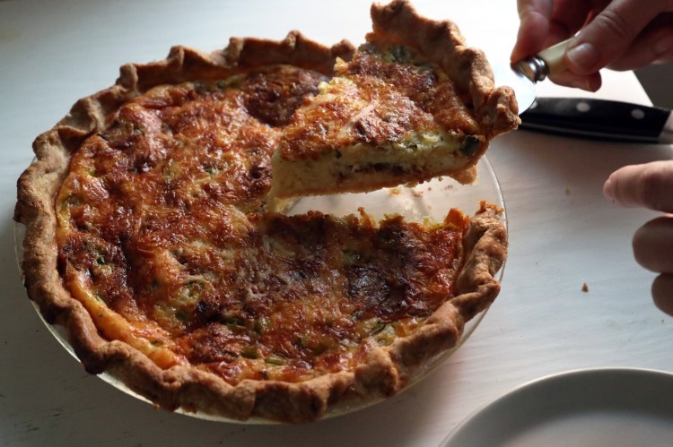Christine Burns Rudalevige serves a slice of a bacon, scallion and cheese quiche with a bacon grease crust.